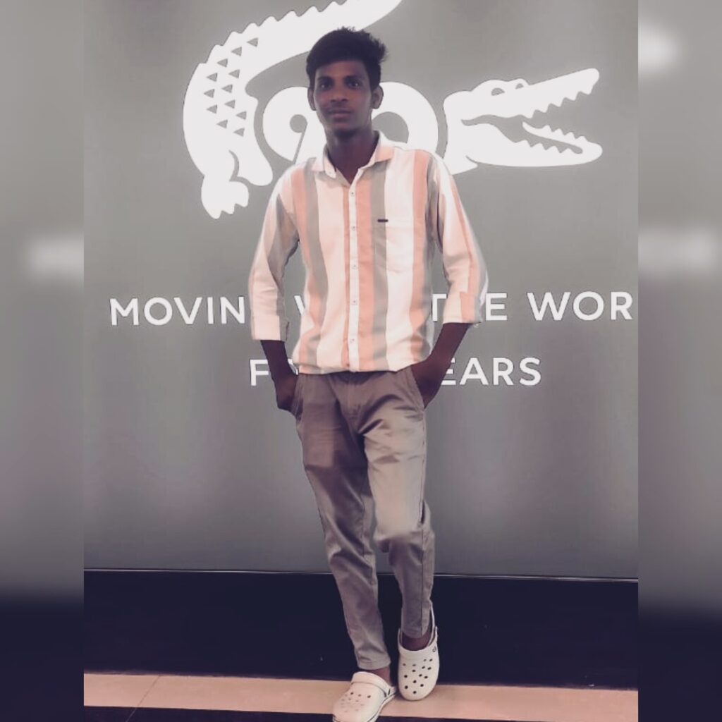 Young man posing stylishly in front of a branded background – flowerindigital, a top digital marketing service in Chennai